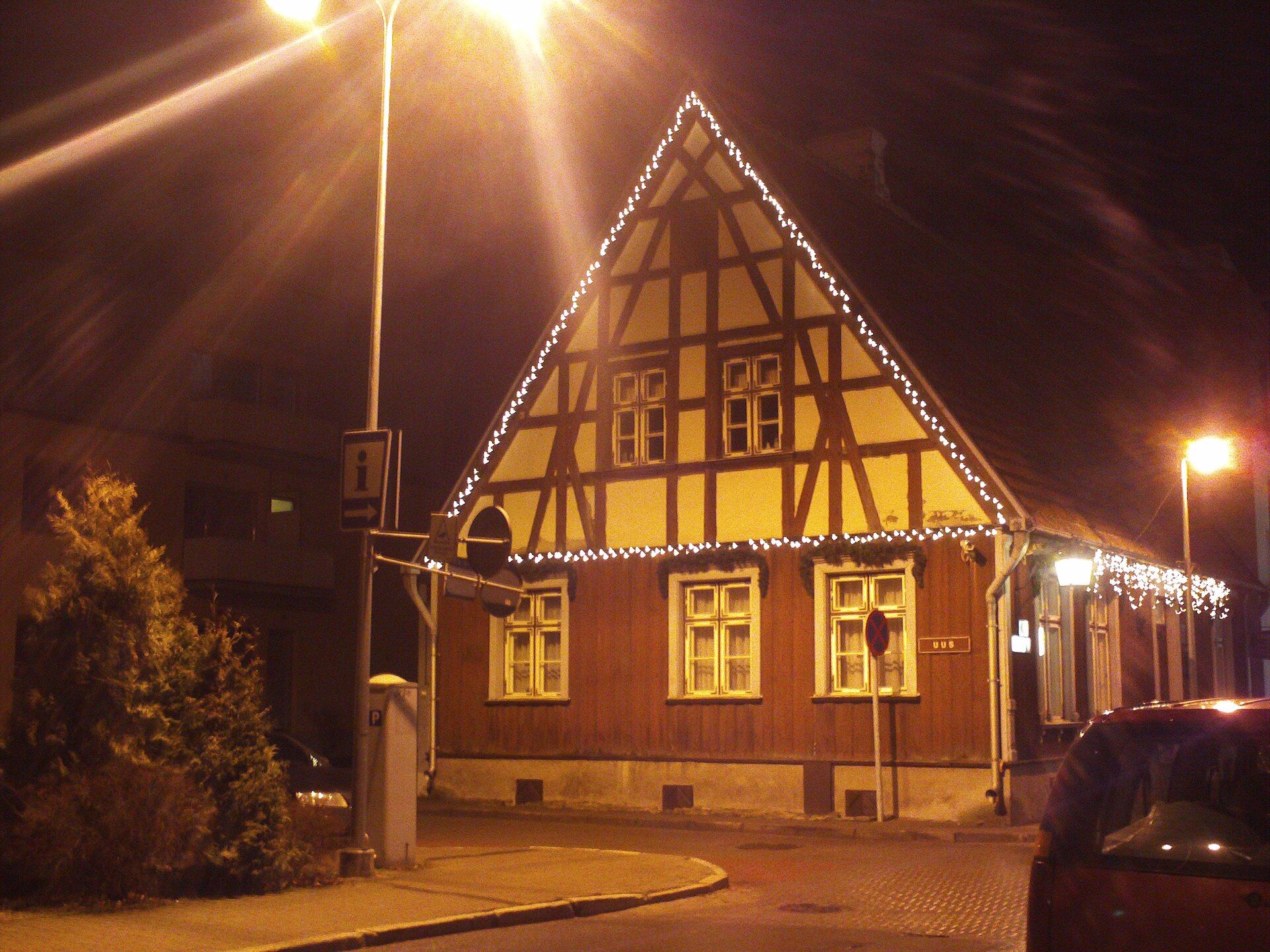 House with its roofline outlined in warm white lights
