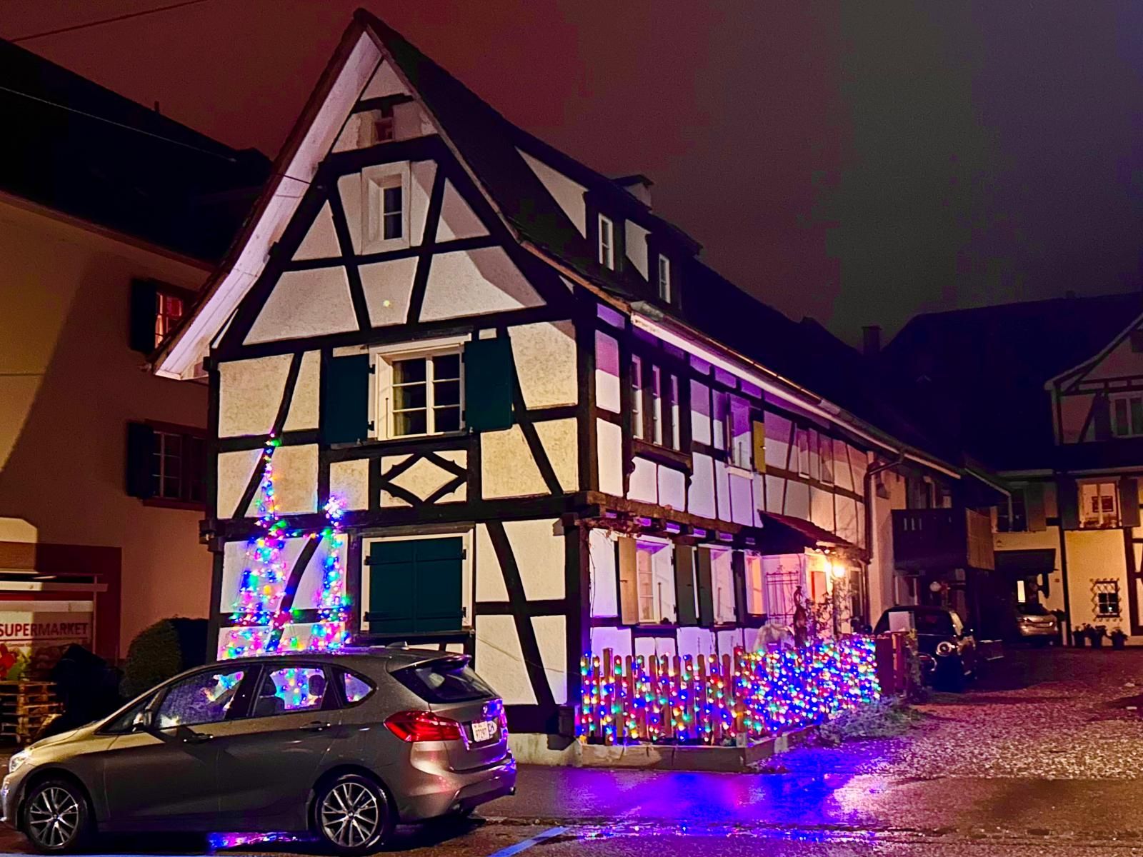 Timber-framed house with colourful Christmas lights